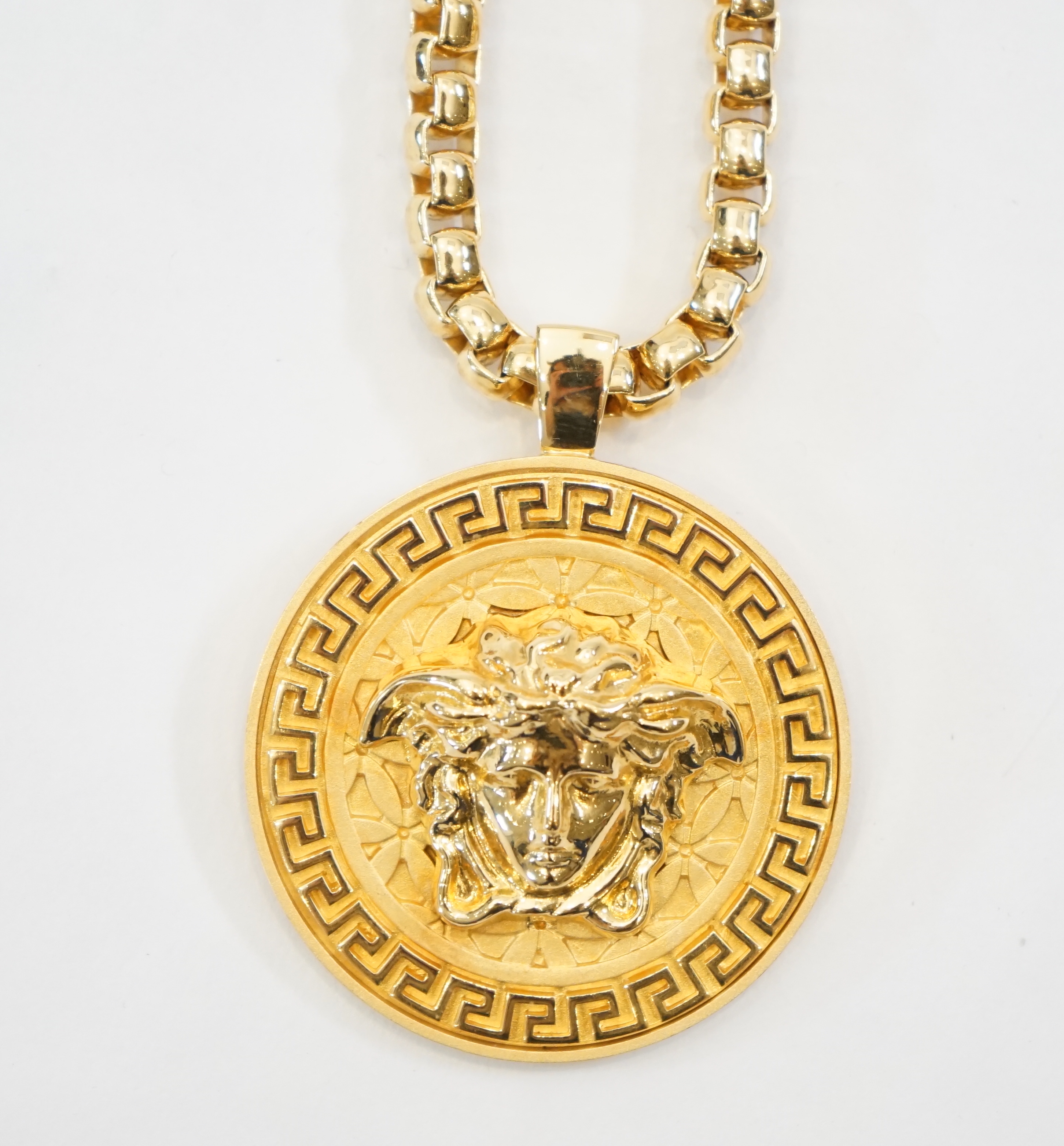 A Versace Medusa gold Greca medallion coin pendant with chunky rapper necklace, chain full length 64cm, medallion 5cm across